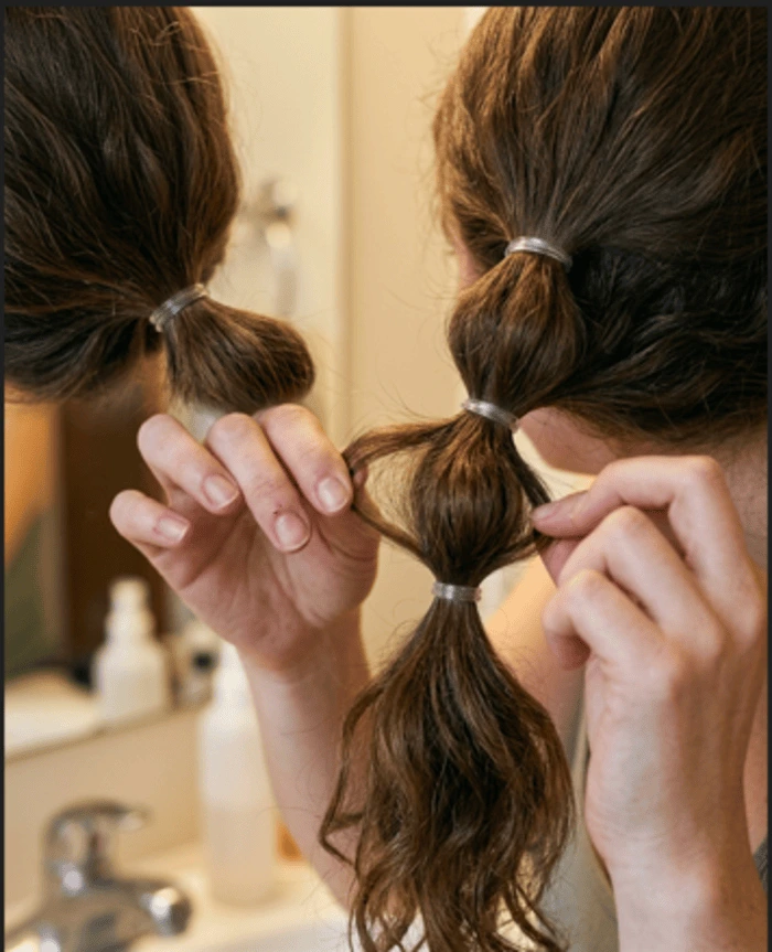 Step-by-step bubble braid ponytail with elastics spaced evenly